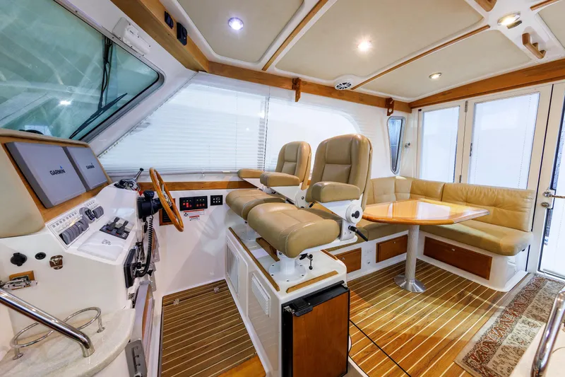 Slide: The Image of Interior of 2011 Back Cove 37 yacht with helm, seating, and wooden flooring. - 30