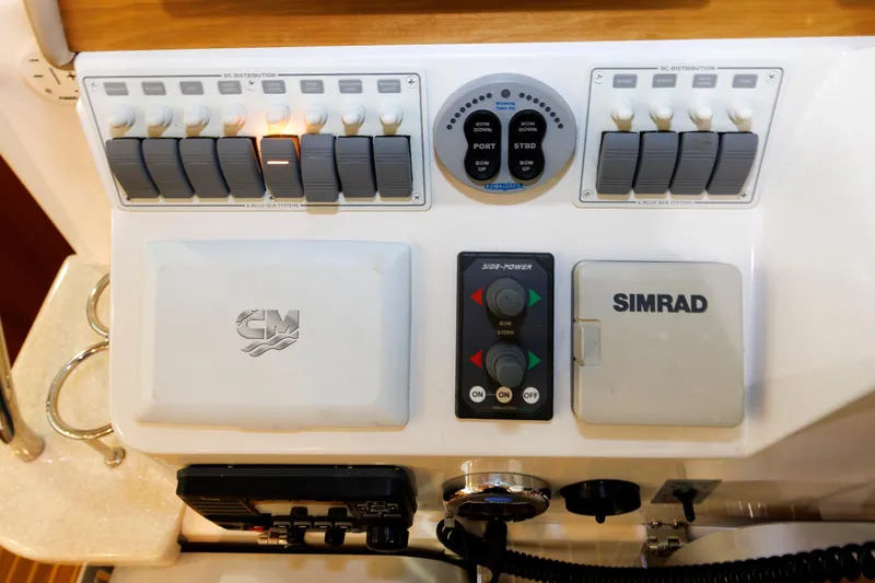 Slide: The Image of Control panel of a 2011 Back Cove 37 boat with Simrad and Side-Power systems. - 36