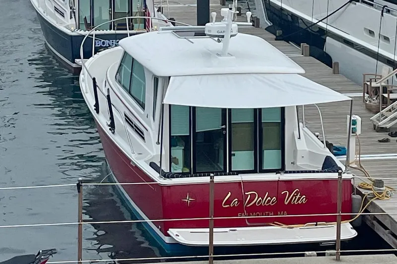 Slide: The Image of 2011 Back Cove 37 boat named "La Dolce Vita" docked at a marina. - 4