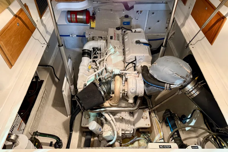 Slide: The Image of Engine compartment of a 2011 Back Cove 37 boat, showcasing detailed mechanical components. - 45