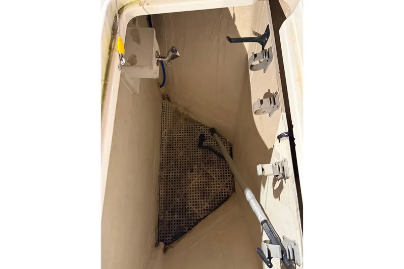 Slide: The Image of 2011 Back Cove 37 boat storage compartment with mounted accessories and drainage system. - 5