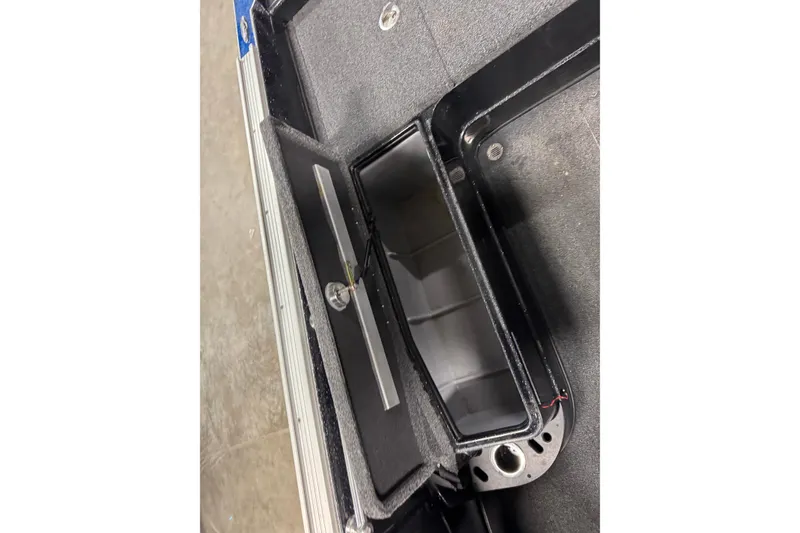 Slide: The Image of Open storage compartment in 2020 Nitro ZV20 boat, featuring a sleek black interior. - 10