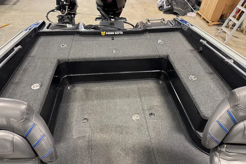 Slide: The Image of Interior of a 2020 Nitro ZV20 boat with Minn Kota motor, featuring spacious seating and carpeted deck. - 6