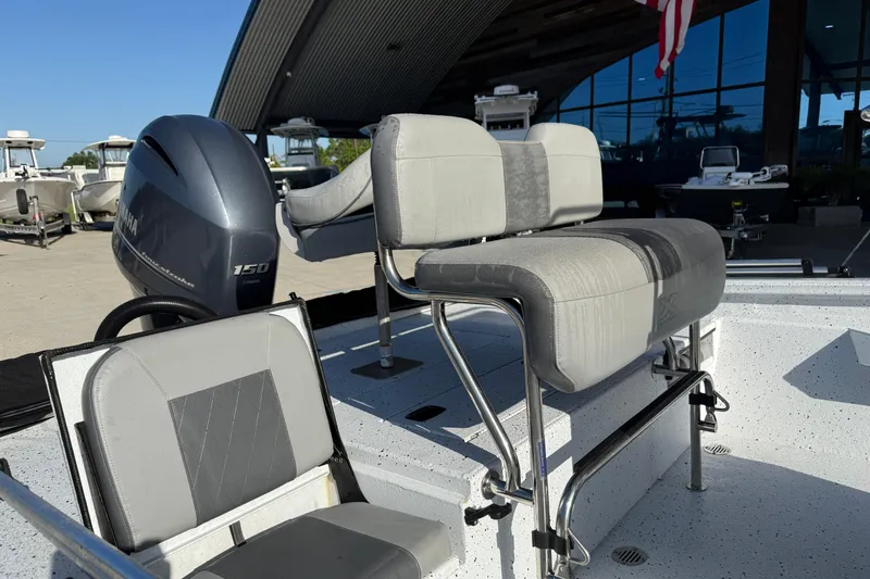 Slide: The Image of 2023 Xpress H22B Bay boat interior with seating and Yamaha 150 engine. - 10