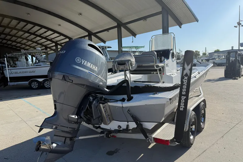 Slide: The Image of 2023 Xpress H22B Bay boat with Yamaha engine in a marina setting. - 3