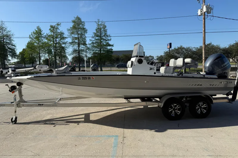Slide: The Image of 2023 Xpress H22B Bay boat on trailer, parked outdoors under clear blue sky. - 5