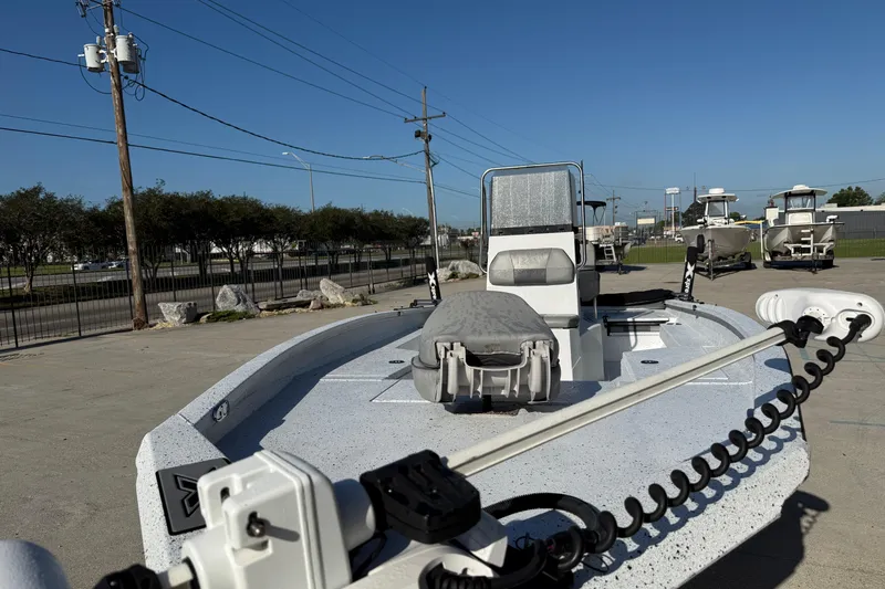 Slide: The Image of 2023 Xpress H22B Bay boat in a parking lot, showcasing sleek design and modern features. - 7