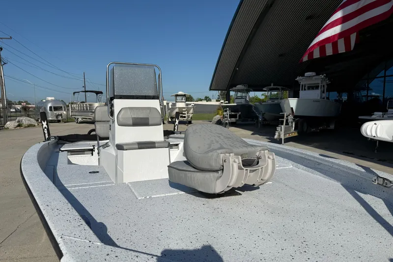 Slide: The Image of 2023 Xpress H22B Bay boat displayed outdoors under a large canopy. - 8