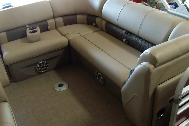 Slide: The Image of 2023 Sun Tracker Party Barge 20 DLX interior with plush seating and cup holders. - 6