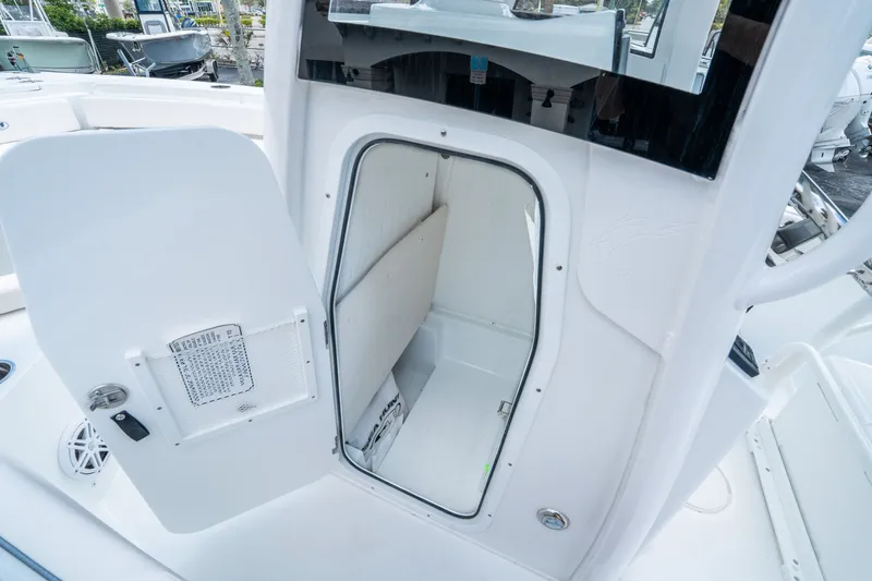 Slide: The Image of Interior of Sea Hunt Ultra 235 SE 2026 with open door. - 16