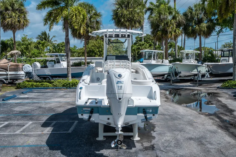 Slide: The Image of Sea Hunt Ultra 235 SE 2026 parked outdoors, surrounded by palm trees. - 3