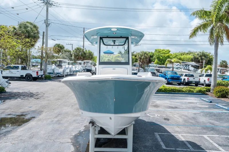 Slide: The Image of 2026 Sea Hunt Ultra 235 SE boat displayed in parking lot. - 7
