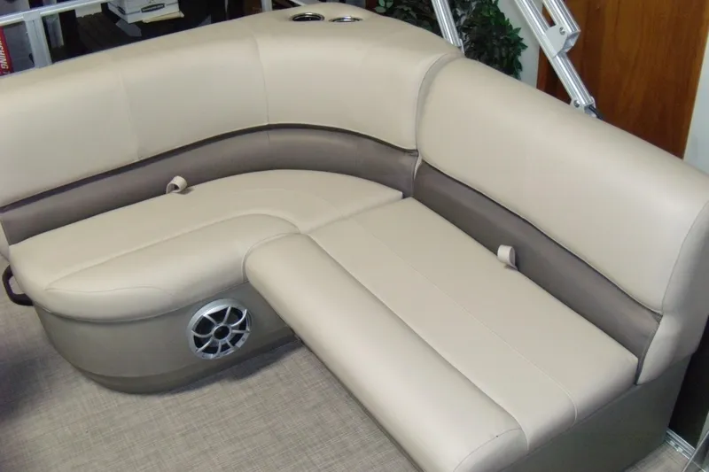Slide: The Image of 2024 Sun Tracker Party Barge 18 DLX seating area with beige upholstery and built-in speaker. - 3