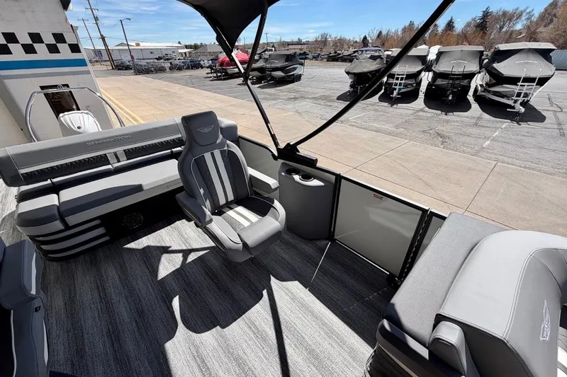 Slide: The Image of 2026 Bennington 23 M Swingback pontoon boat interior with gray seating and open deck. - 10