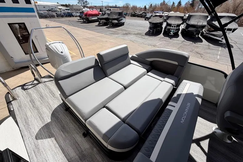 Slide: The Image of 2026 Bennington 23 M Swingback pontoon boat with gray seating and outdoor setting. - 14