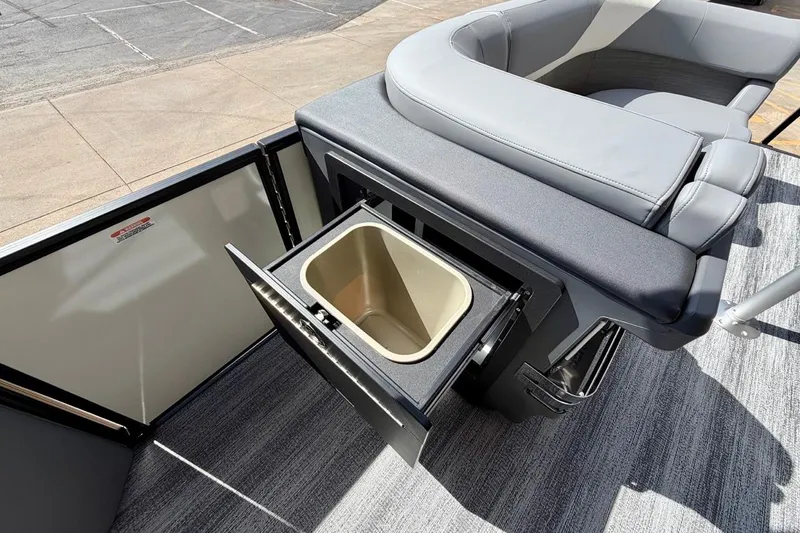 Slide: The Image of 2026 Bennington 23 M Swingback boat interior with open storage compartment and seating. - 20