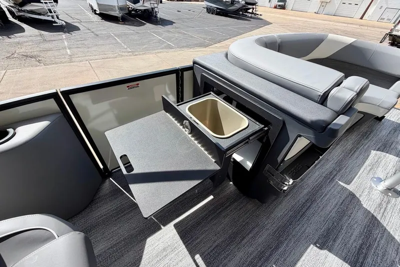 Slide: The Image of 2026 Bennington 23 M Swingback boat interior with seating and storage compartment. - 21