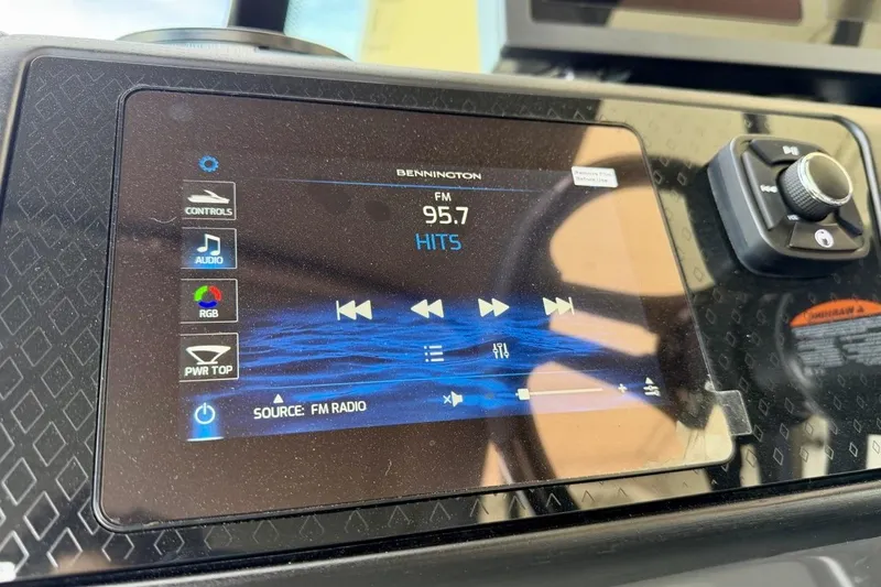 Slide: The Image of Touchscreen display in 2026 Bennington 23 M Swingback showing FM radio controls. - 25