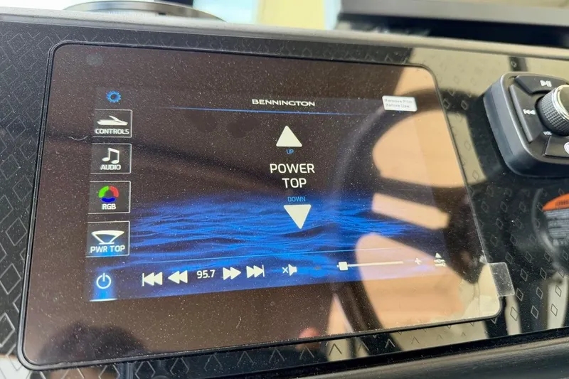 Slide: The Image of Touchscreen control panel of a 2026 Bennington 23 M Swingback boat, displaying audio and power top options. - 26