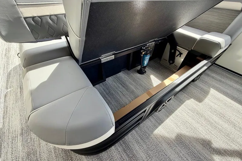 Slide: The Image of 2026 Bennington 23 M Swingback boat interior storage compartment with open seat and hydraulic lift. - 29
