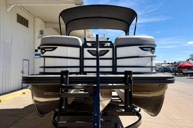Slide: The Image of 2026 Bennington 23 M Swingback pontoon boat on trailer, parked outdoors. - 3