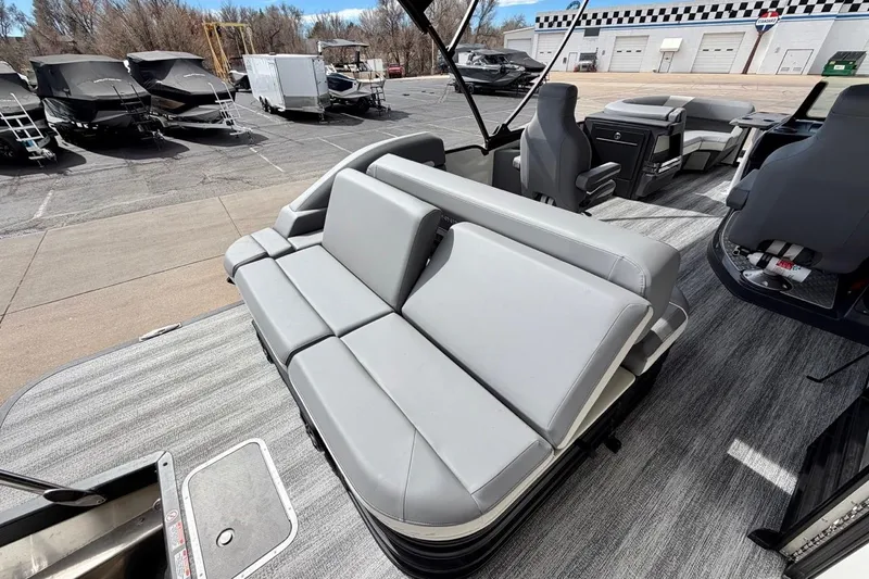 Slide: The Image of 2026 Bennington 23 M Swingback pontoon boat with sleek gray seating and modern design. - 30