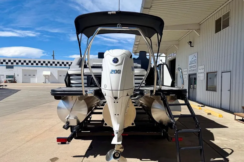 Slide: The Image of 2026 Bennington 23 M Swingback pontoon boat with Yamaha 200 engine at service entrance. - 5