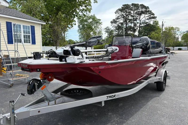 The Image of Red 2025 Thor Lake Hammer 1900CC Elite boat on trailer, parked outdoors. - 0