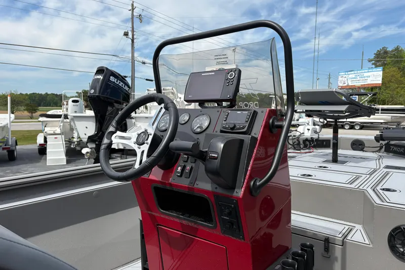 Slide: The Image of 2025 Thor Lake Hammer 1900CC Elite boat dashboard with steering wheel and controls. - 10