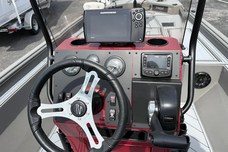 Slide: The Image of 2025 Thor Lake Hammer 1900CC Elite boat dashboard with steering wheel and navigation system. - 12