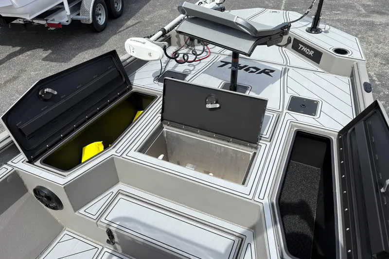 Slide: The Image of 2025 Thor Lake Hammer 1900CC Elite boat deck with open storage compartments. - 14