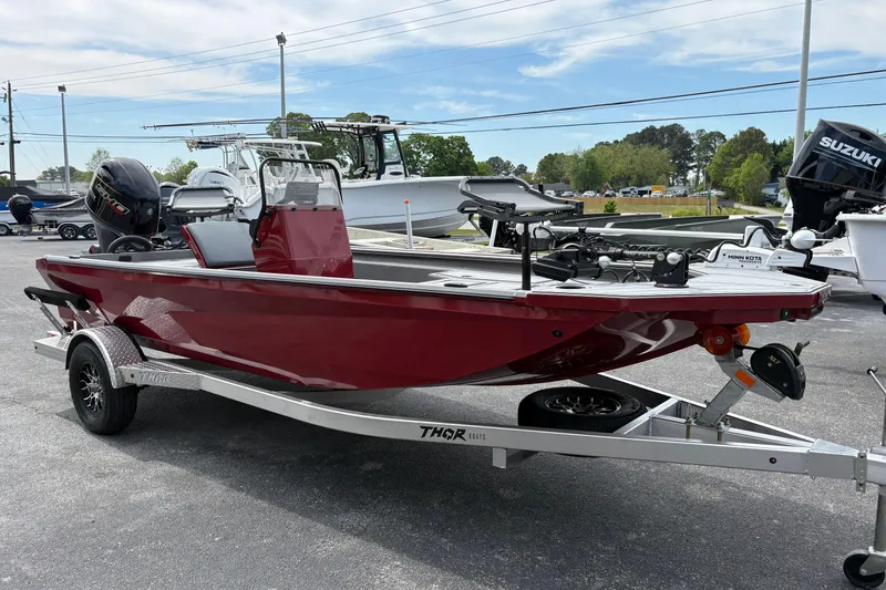 Slide: The Image of 2025 Thor Lake Hammer 1900CC Elite boat on trailer, red exterior, parked outdoors. - 4