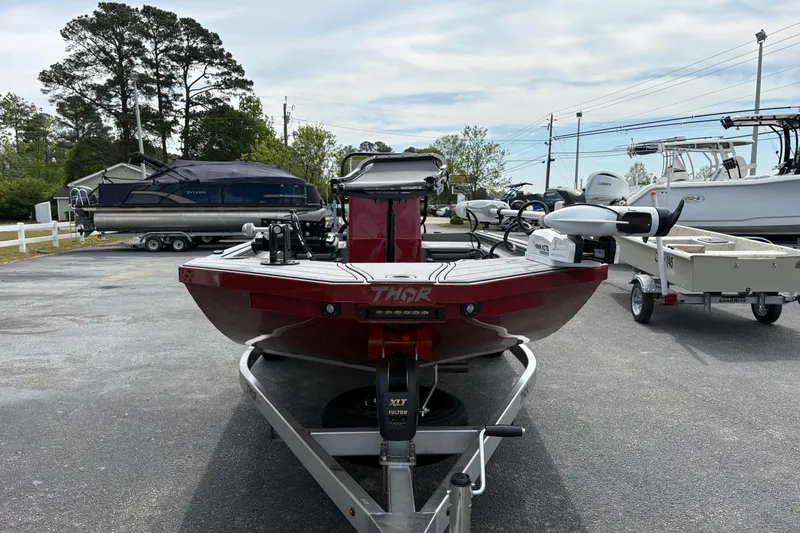 Slide: The Image of 2025 Thor Lake Hammer 1900CC Elite boat on trailer in parking lot. - 7