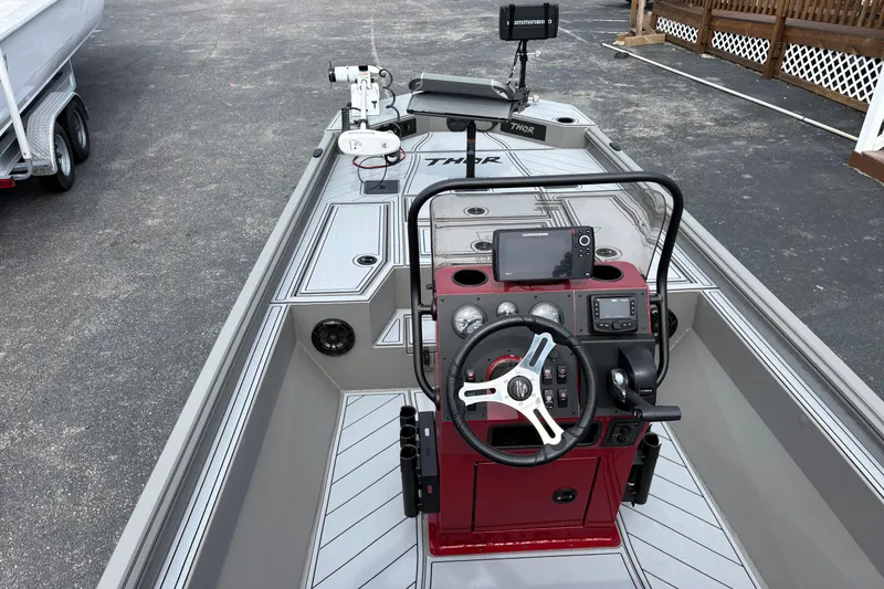 Slide: The Image of 2025 Thor Lake Hammer 1900CC Elite boat interior with advanced navigation controls and sleek design. - 9
