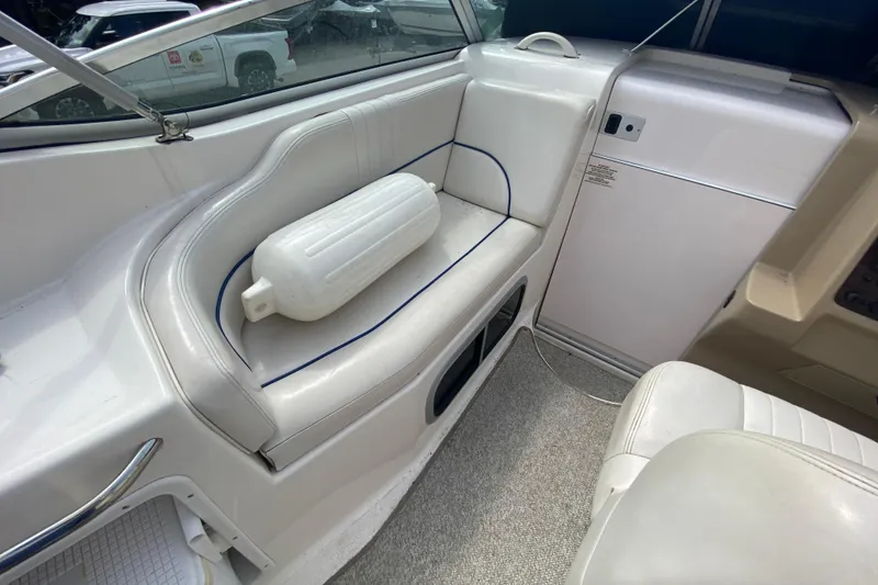 Slide: The Image of Interior of a 2002 Chaparral Signature 240 boat with white seating and a fender. - 13