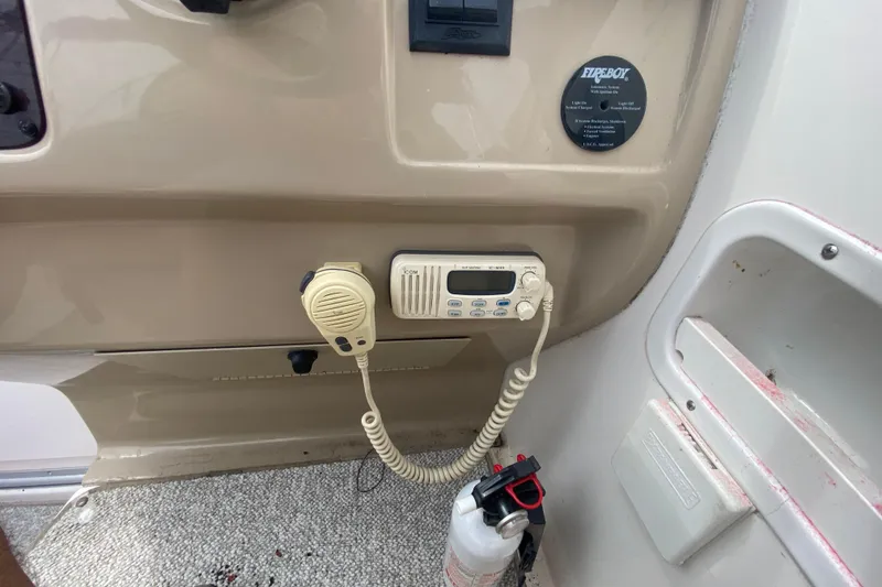 Slide: The Image of 2002 Chaparral Signature 240 boat dashboard with radio and fire extinguisher. - 15