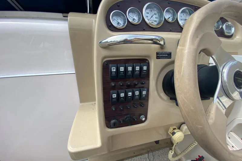 Slide: The Image of Control panel of a 2002 Chaparral Signature 240 boat with gauges and switches. - 16