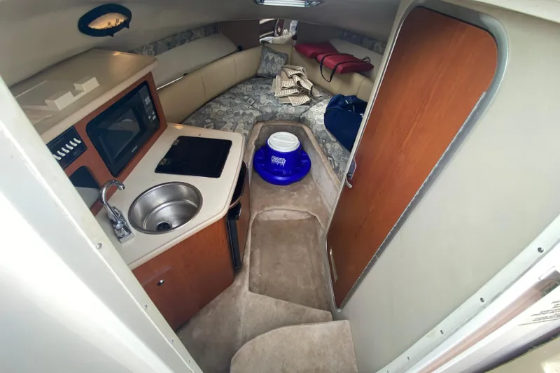 Slide: The Image of 2002 Chaparral Signature 240 cabin interior with kitchenette and seating area. - 18