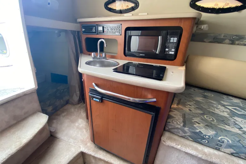 Slide: The Image of 2002 Chaparral Signature 240 cabin interior with kitchenette, microwave, and sink. - 20