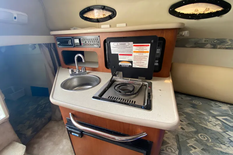 Slide: The Image of 2002 Chaparral Signature 240 boat interior with kitchenette, sink, and stove. - 21