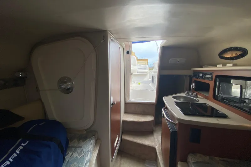 Slide: The Image of Interior of 2002 Chaparral Signature 240 boat with kitchenette and seating area. - 23