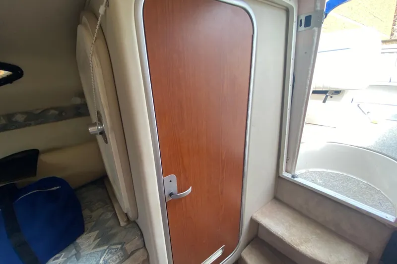 Slide: The Image of Interior cabin view of 2002 Chaparral Signature 240 boat with wooden door. - 24