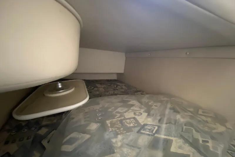Slide: The Image of Interior cabin of 2002 Chaparral Signature 240 boat with patterned bedding. - 27