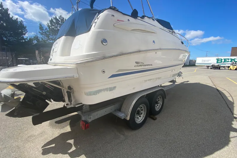 Slide: The Image of 2002 Chaparral Signature 240 boat on trailer in sunny parking lot. - 3