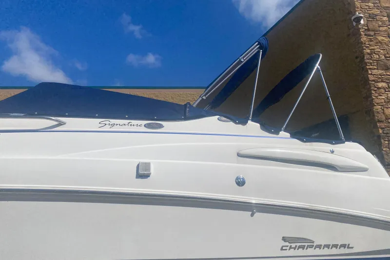 Slide: The Image of 2002 Chaparral Signature 240 boat with blue canopy against a clear sky. - 6