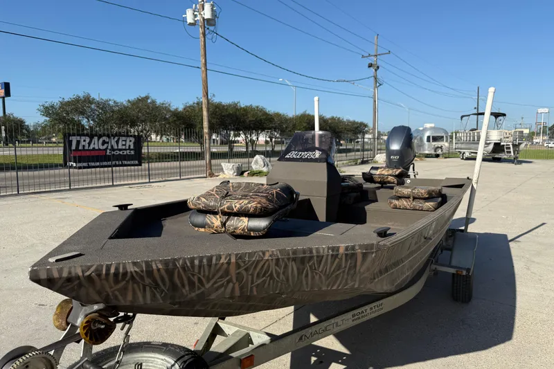 Slide: The Image of 2020 Alweld 1748 Flat Marsh Console SC boat on trailer, camo seats, outdoor setting. - 4