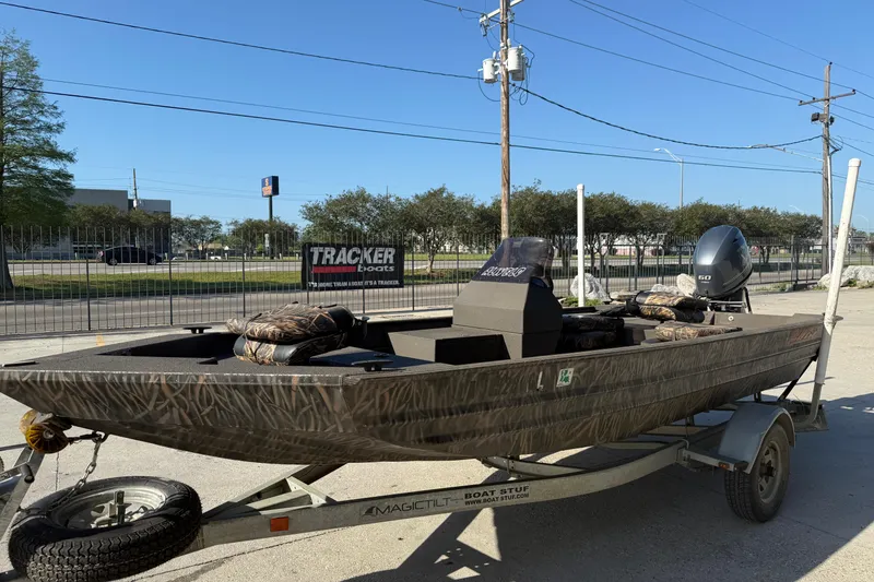 Slide: The Image of 2020 Alweld 1748 Flat Marsh Console SC boat on trailer, camo design, outdoor setting. - 5