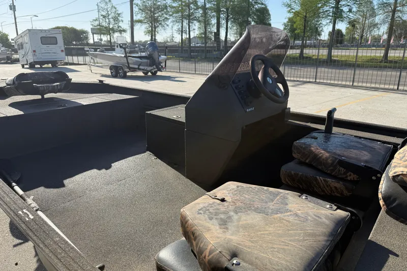 Slide: The Image of 2020 Alweld 1748 Flat Marsh Console SC boat interior with camo seats and steering console. - 8