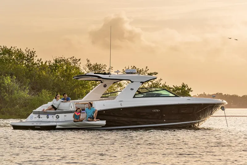 Slide: The Image of Manufacturer Provided Image: 2023 Sea Ray SLX 400 luxury boat cruising on a serene lake at sunset. - 10