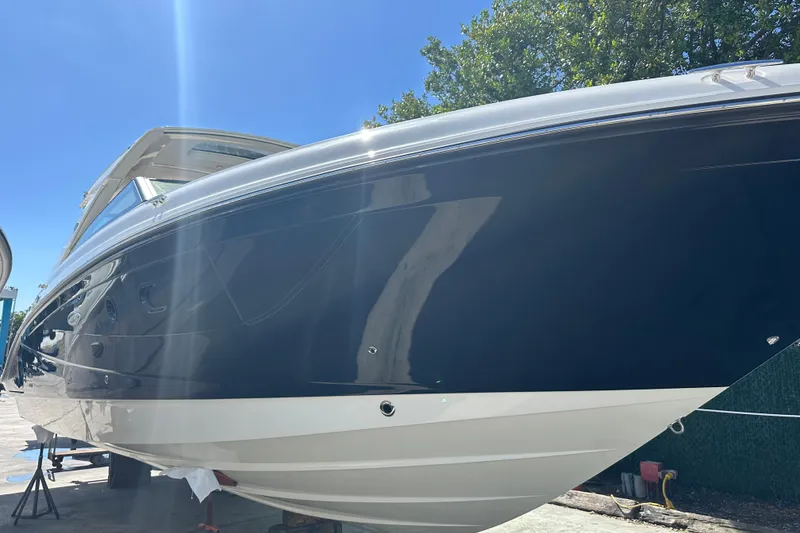 Slide: The Image of 2023 Sea Ray SLX 400 boat with sleek design under clear blue sky. - 11